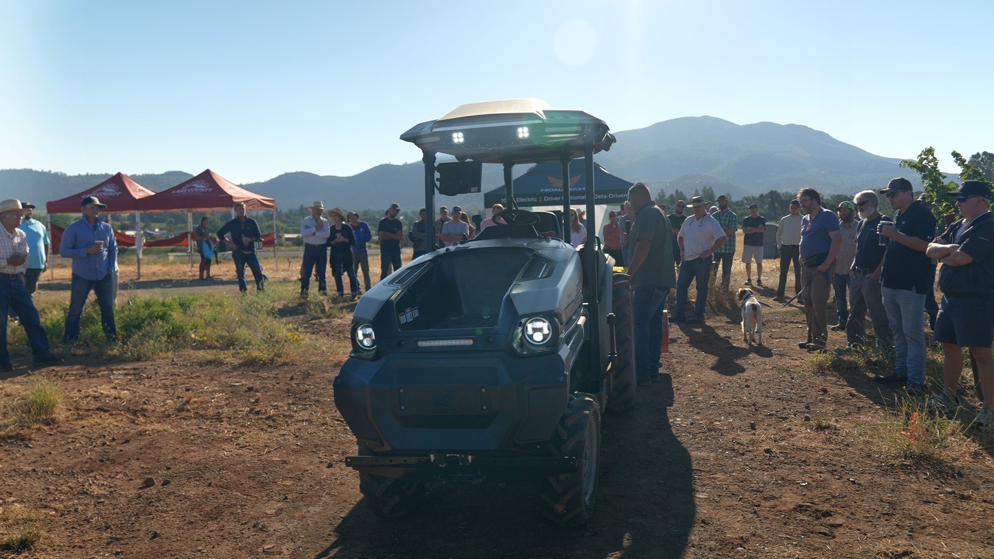 The Monarch tractor surrounded by a large gathering of demo attendees