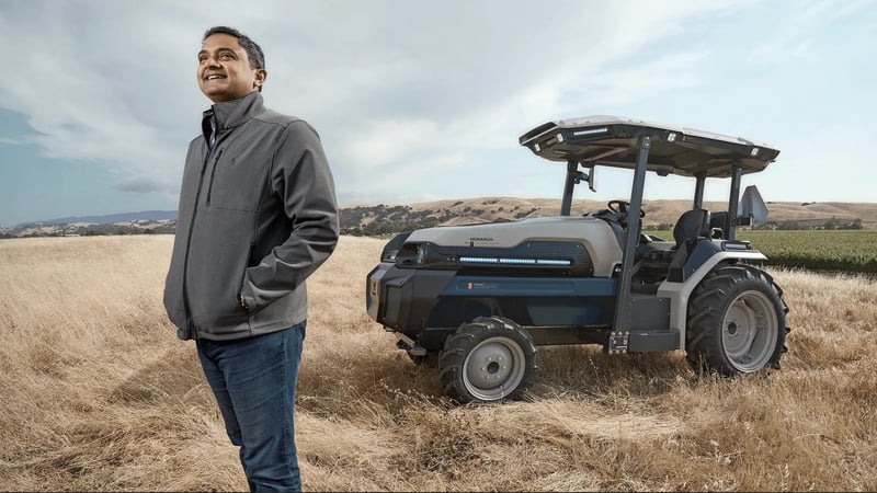 praveen posing by the tractor